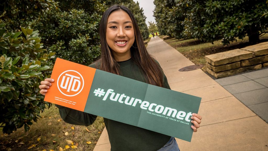 student holding a future comet sign