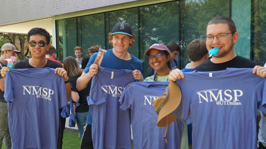 Students holding NMSP shirts