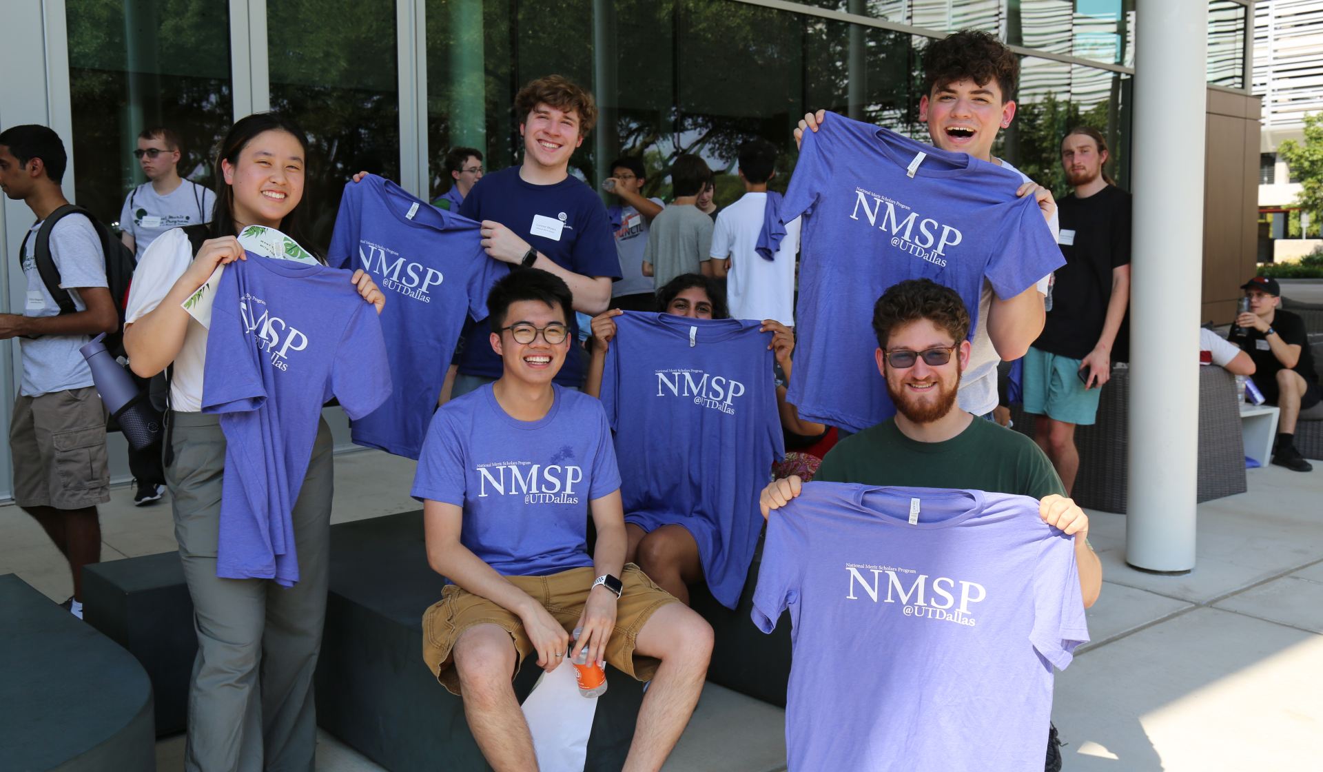 National Merit Scholars hold up T-shirts